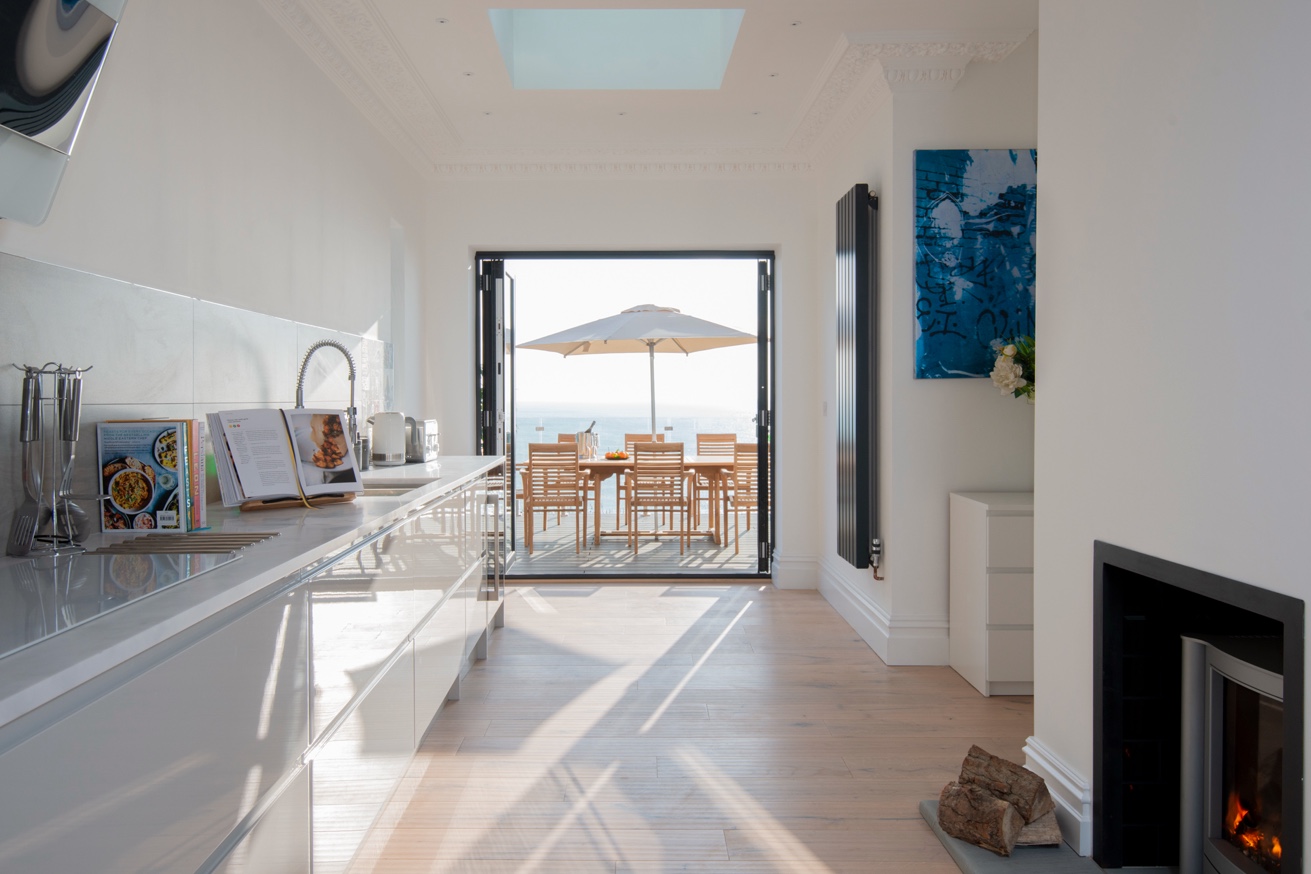 Cliffhanger House — kitchen opening onto sun deck with panoramic sea views, St Leonards-on-Sea