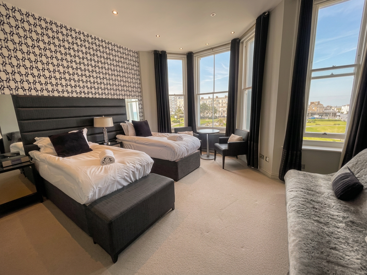 Hastings House twin bedroom with black and white wallpaper and sea view